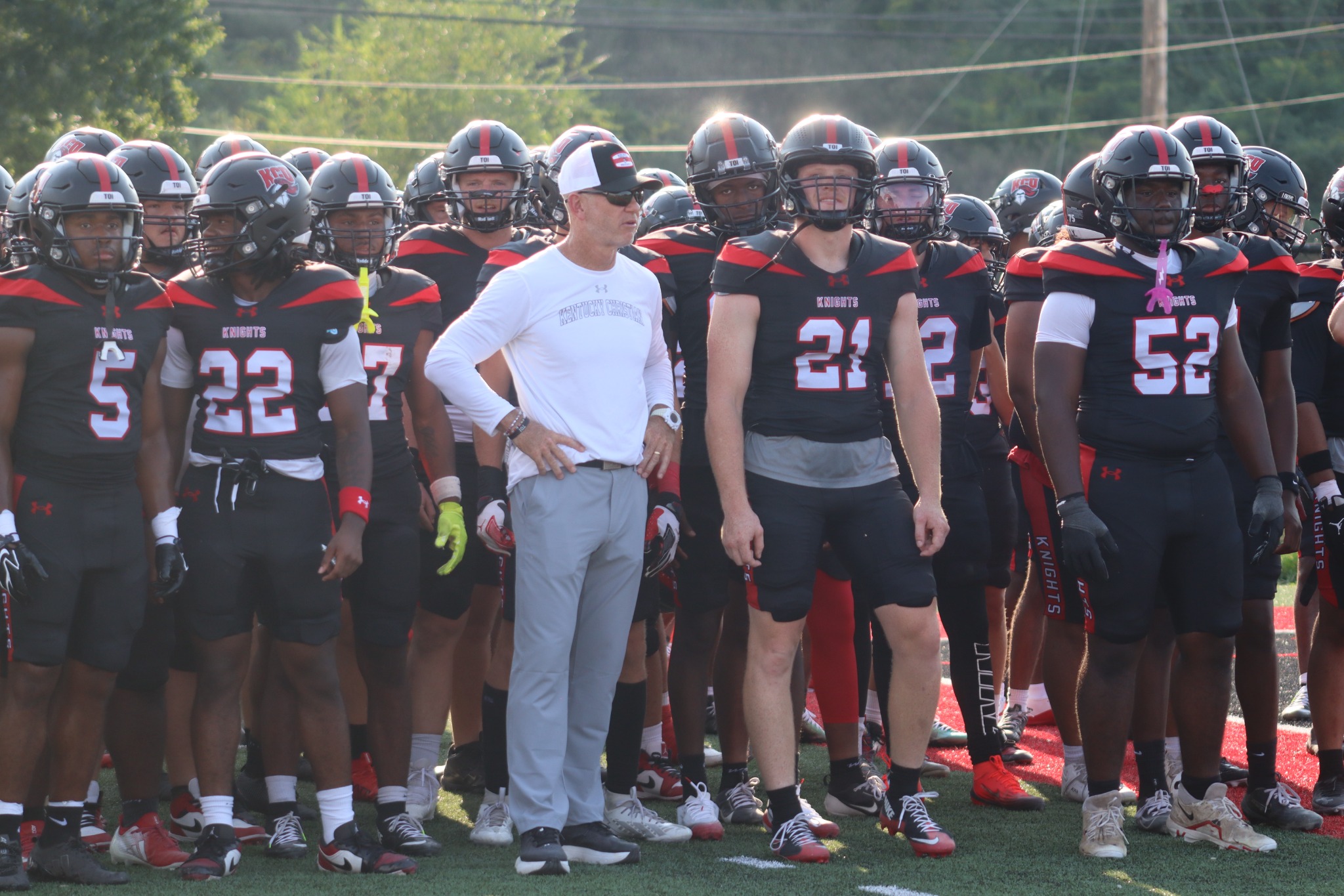 Coach Jason Aubry surrounded by the Kentucky Christian University football action against Morehead State